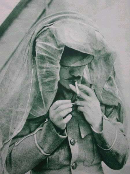 A British soldier trying to keep the flies off